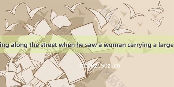 A man was walking along the street when he saw a woman carrying a large box. It was half i